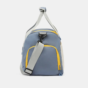 Colorblock gym duffel bag in Dusty Blue with yellow trim and grey straps.