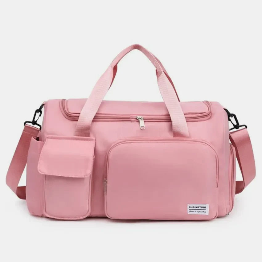 Dusty Pink canvas duffel bag with multiple utility pockets and adjustable strap.