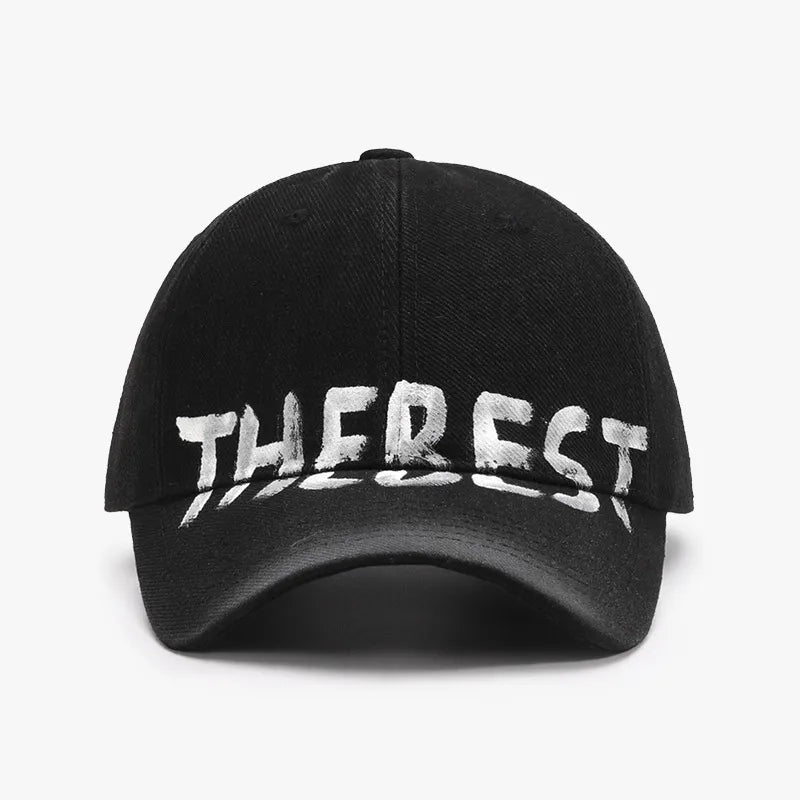 Black baseball cap with textured denim and white "THEREST" graphic.