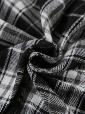 Oversized button-up shirt in black and white plaid cotton fabric.
