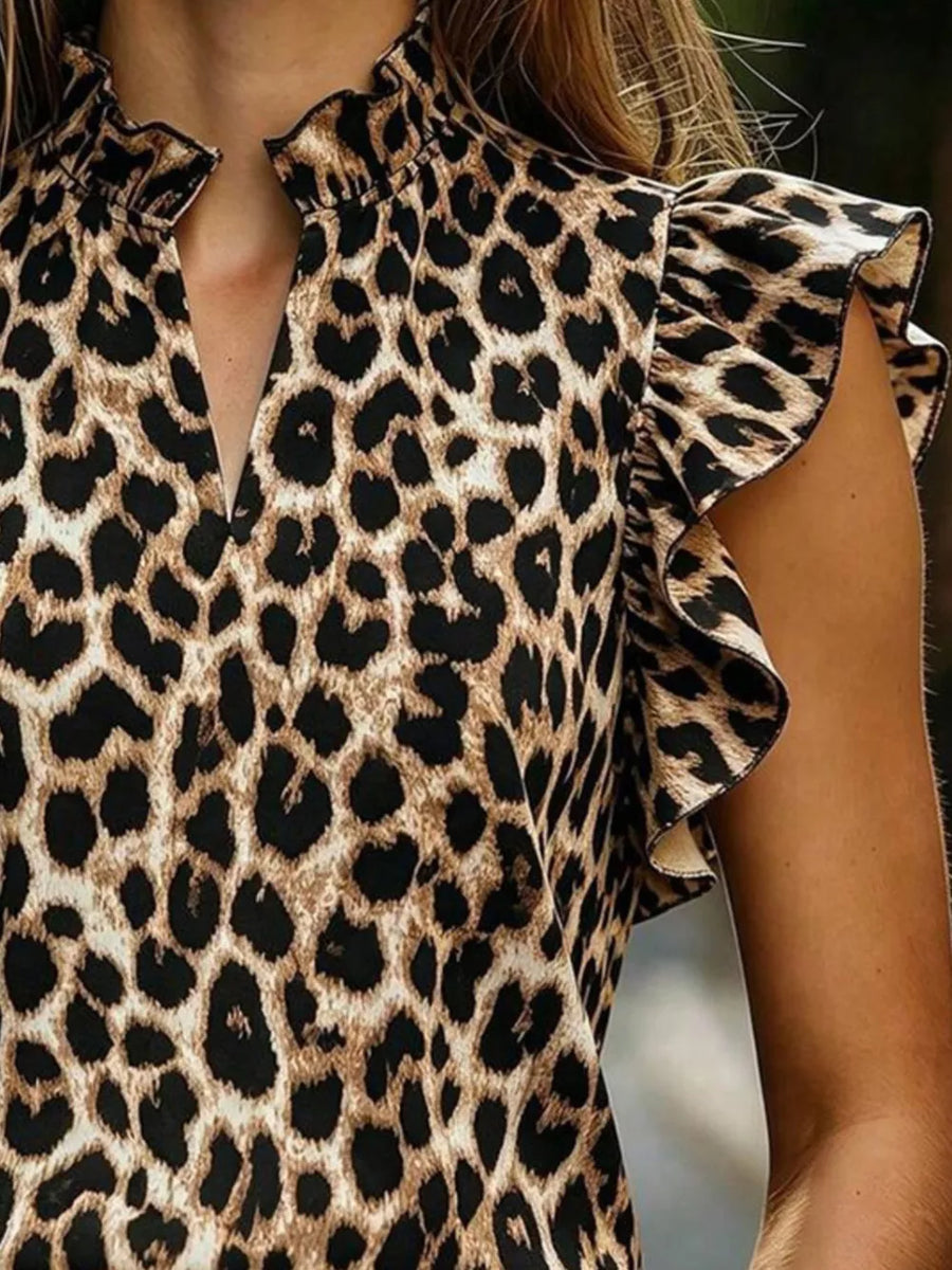 Leopard print t-shirt with ruffled cap sleeves and a mock neck with keyhole detail.
