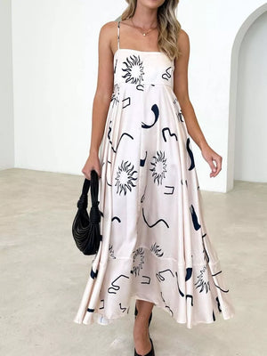Blush pink maxi dress with spaghetti straps and abstract black print.