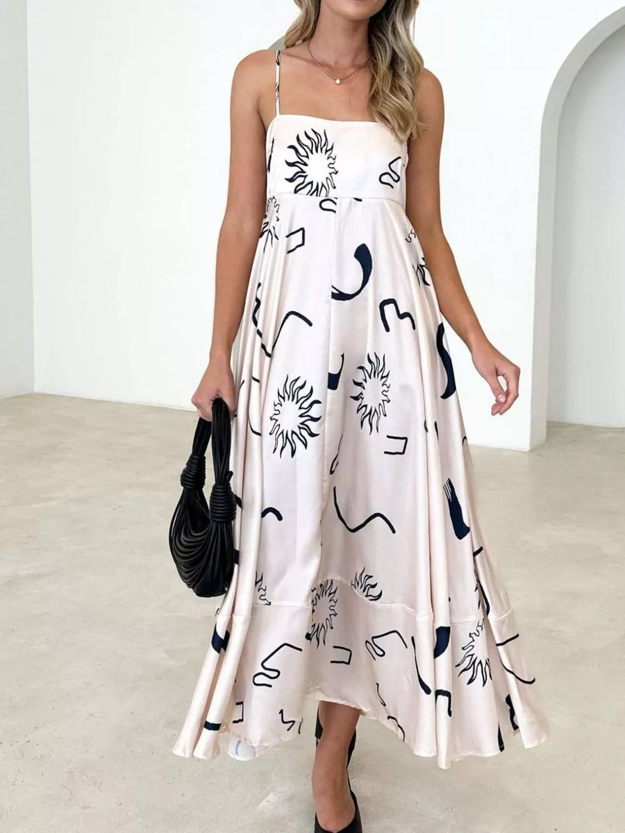 Blush pink maxi dress with spaghetti straps and abstract black print.