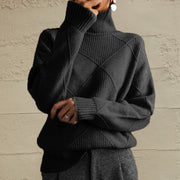 Black turtleneck sweater with diamond knit pattern and ribbed details.