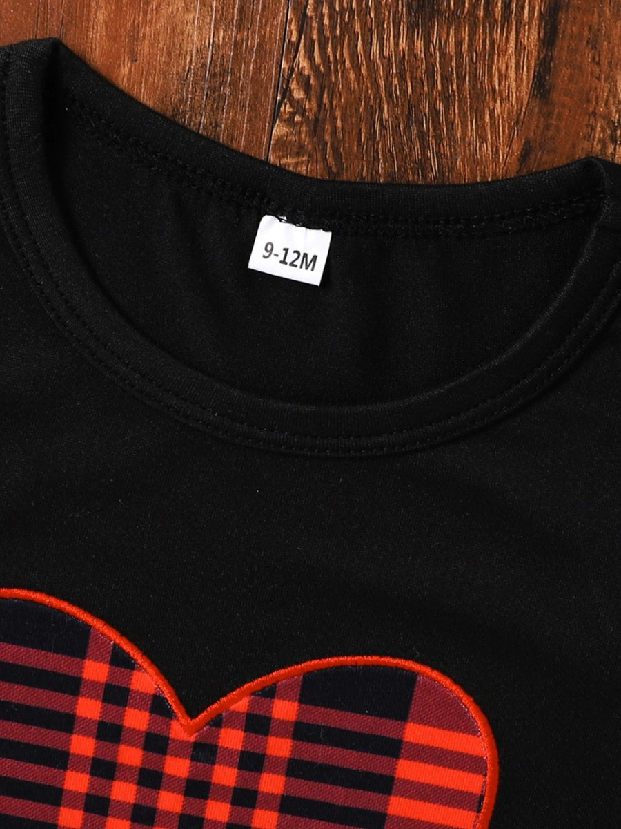 Black baby set with red plaid heart appliqué and ruffle trim detail.