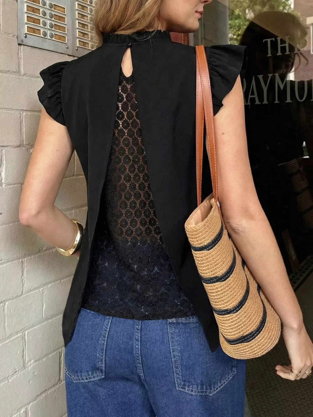 Black cap sleeve blouse with ruffled details and lace back panel