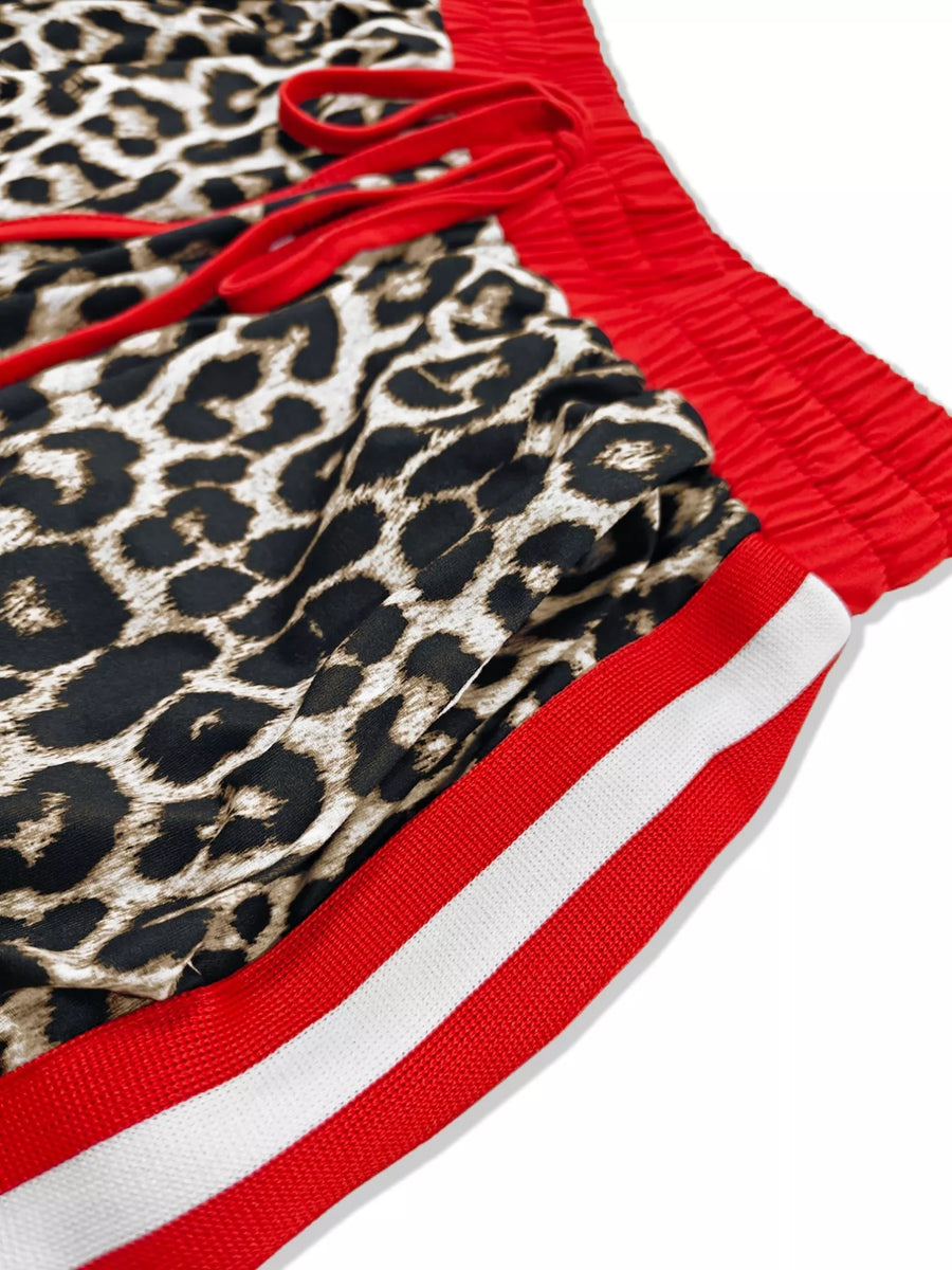 Leopard print lounge shorts with red drawstring and red and white striped trim.
