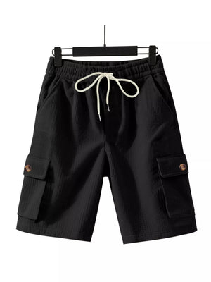 Black textured drawstring cargo shorts with button-flap pockets.