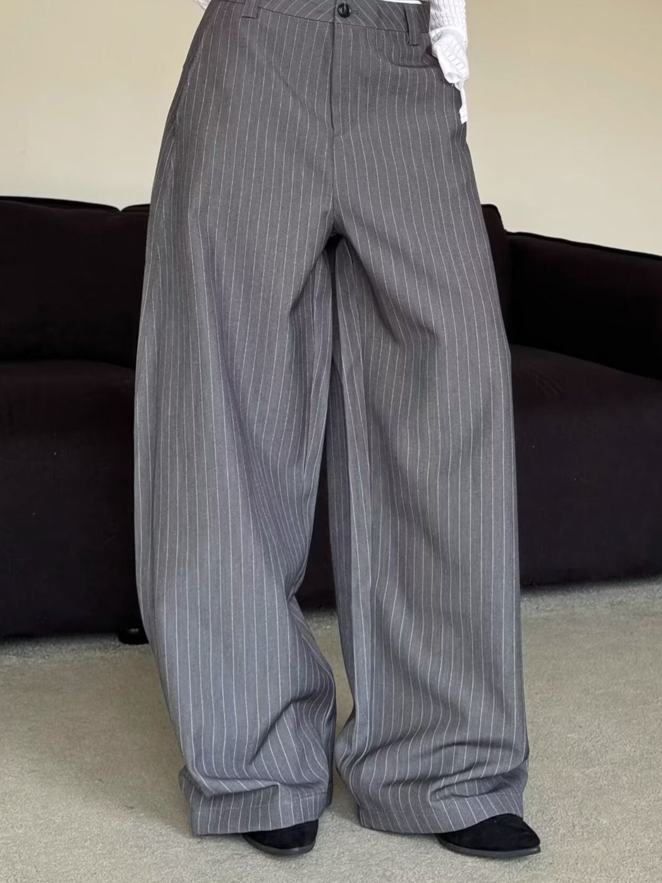 Men's grey pinstripe wide leg sweatpants with a relaxed fit.