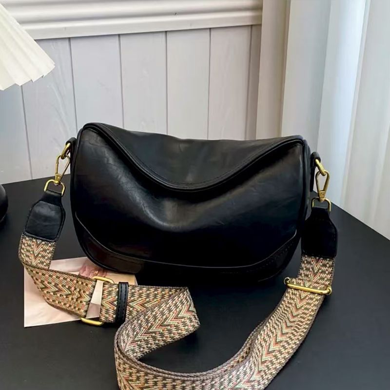 Black vintage wide strap crossbody bag with adjustable patterned strap