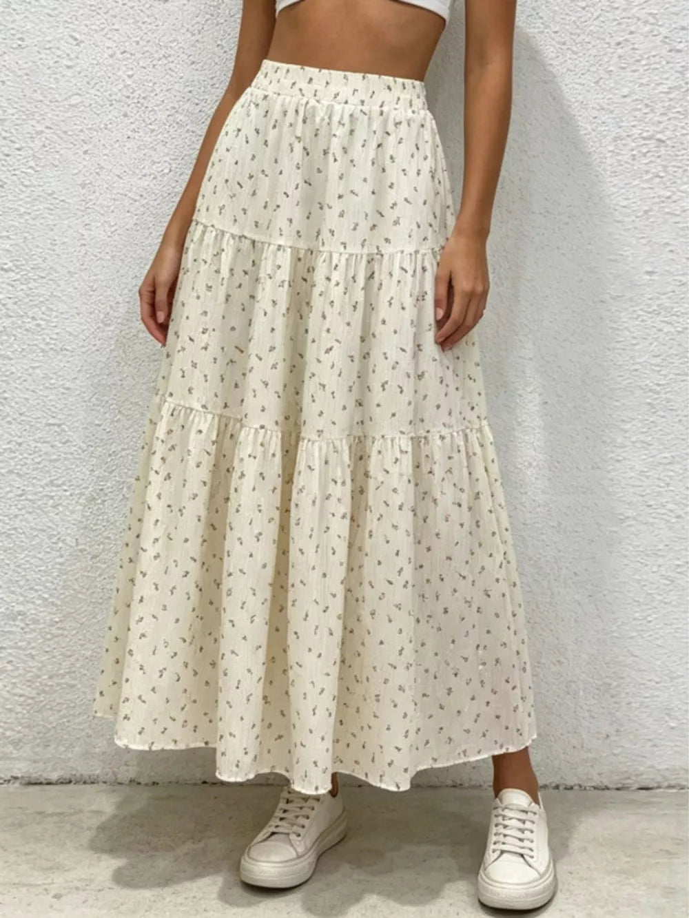 Ruched floral tiered maxi skirt in beige with a ruffled hem and elastic waist.