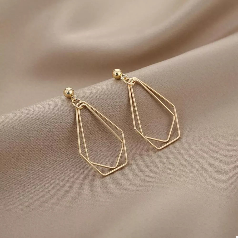 gold earrings with geometric and null