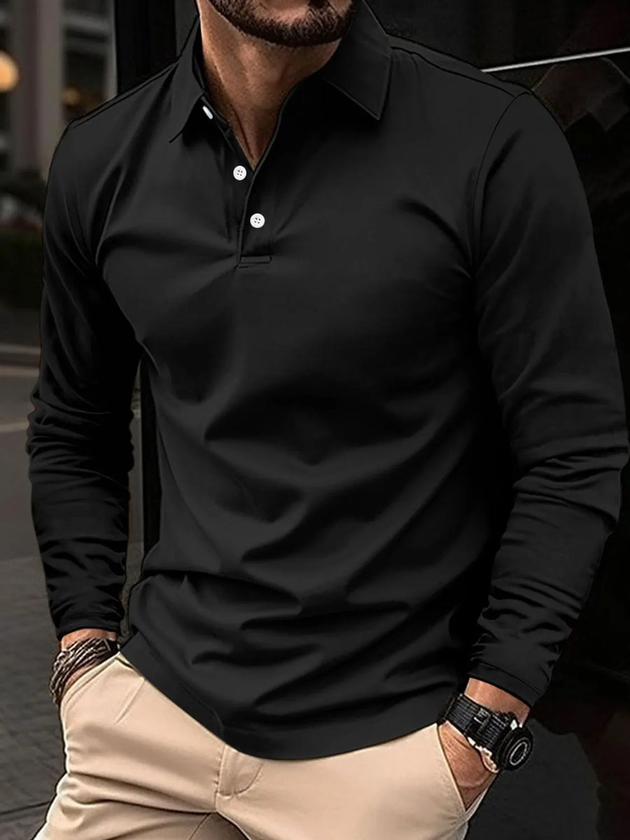 Black long sleeve polo shirt with white buttons, worn by a man with hands in pockets.