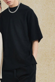Black waffle knit boxy t-shirt with crew neck and short sleeves.