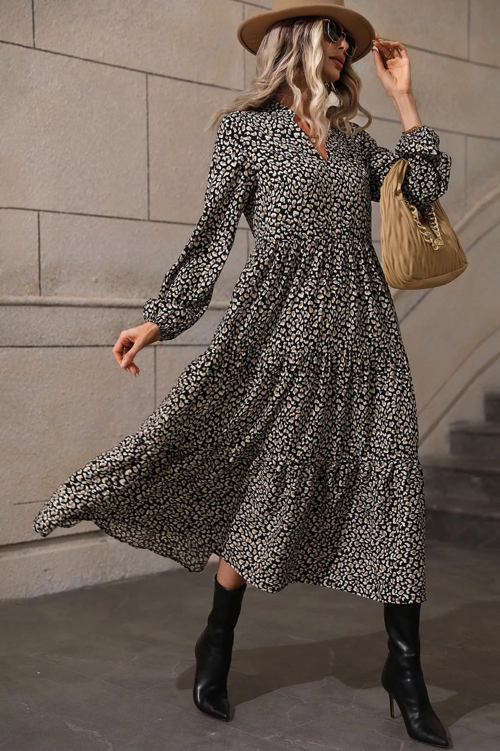 Chic black animal print midi dress with balloon sleeves and tiered skirt.