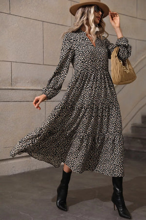 Chic black animal print midi dress with balloon sleeves and tiered skirt.