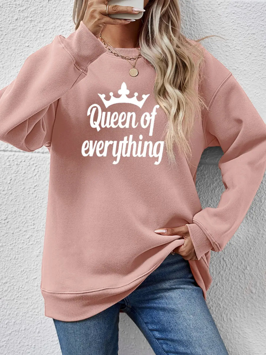 Blush pink graphic sweatshirt with white Queen of Everything text and crown graphic.