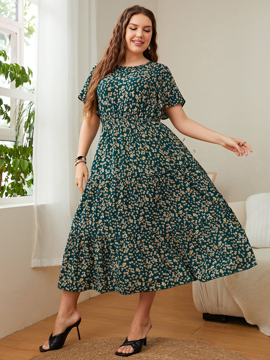 Emerald floral midi dress with tiered skirt and short sleeves.