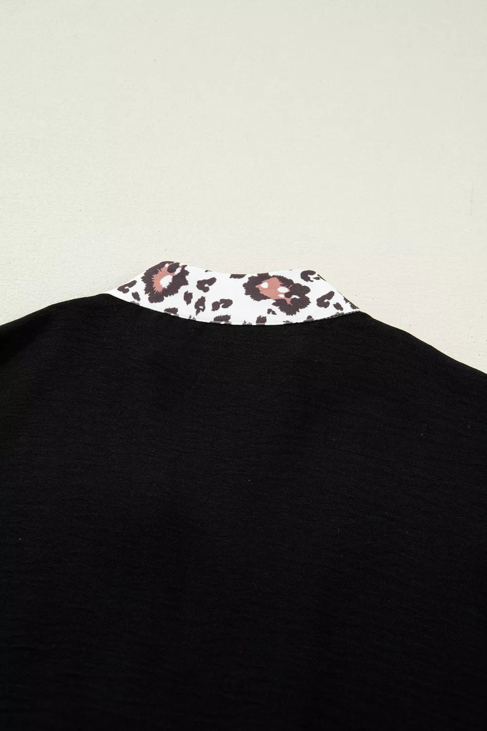Black polyester tunic with leopard print notched neckline detail
