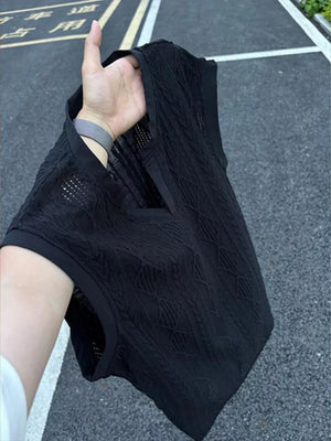 Black textured knit tank top with relaxed V-neck and open weave detail.