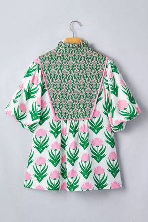 White polyester blouse with pink floral print, green patterned yoke, and puff sleeves.