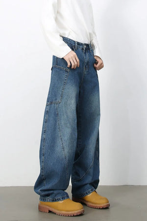 Medium wash denim balloon trousers with unique paneling and a wide leg.