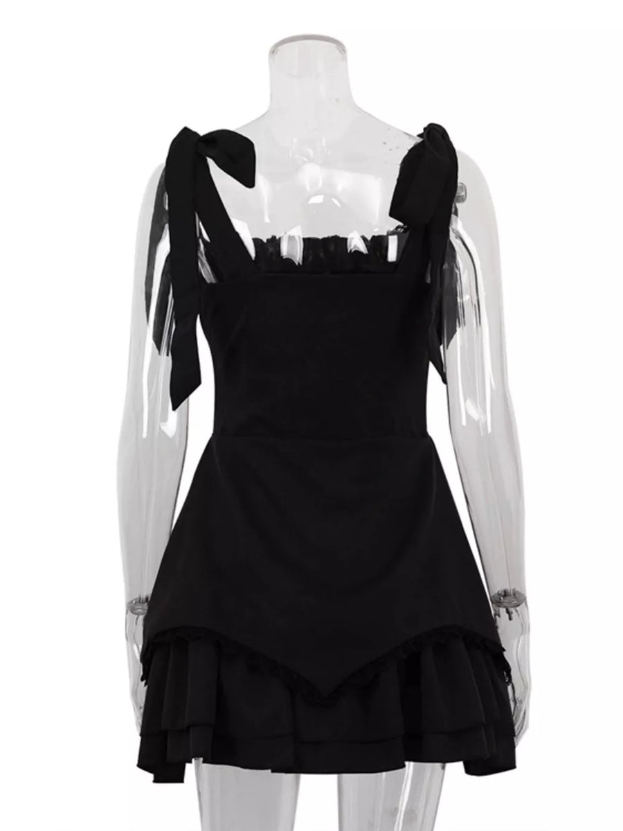 Black mini dress with tie straps, ruffled neckline, and tiered ruffled hem.
