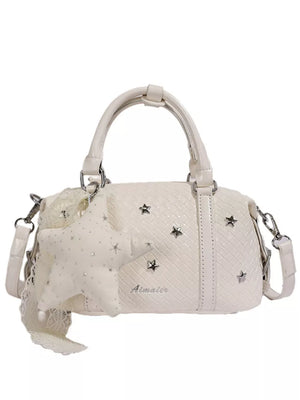 crossbody bag in pale yellow with star embellishments and mini