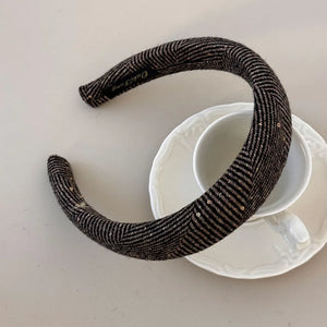 Textured tweed padded headband in coffee brown with subtle sequins and herringbone pattern.