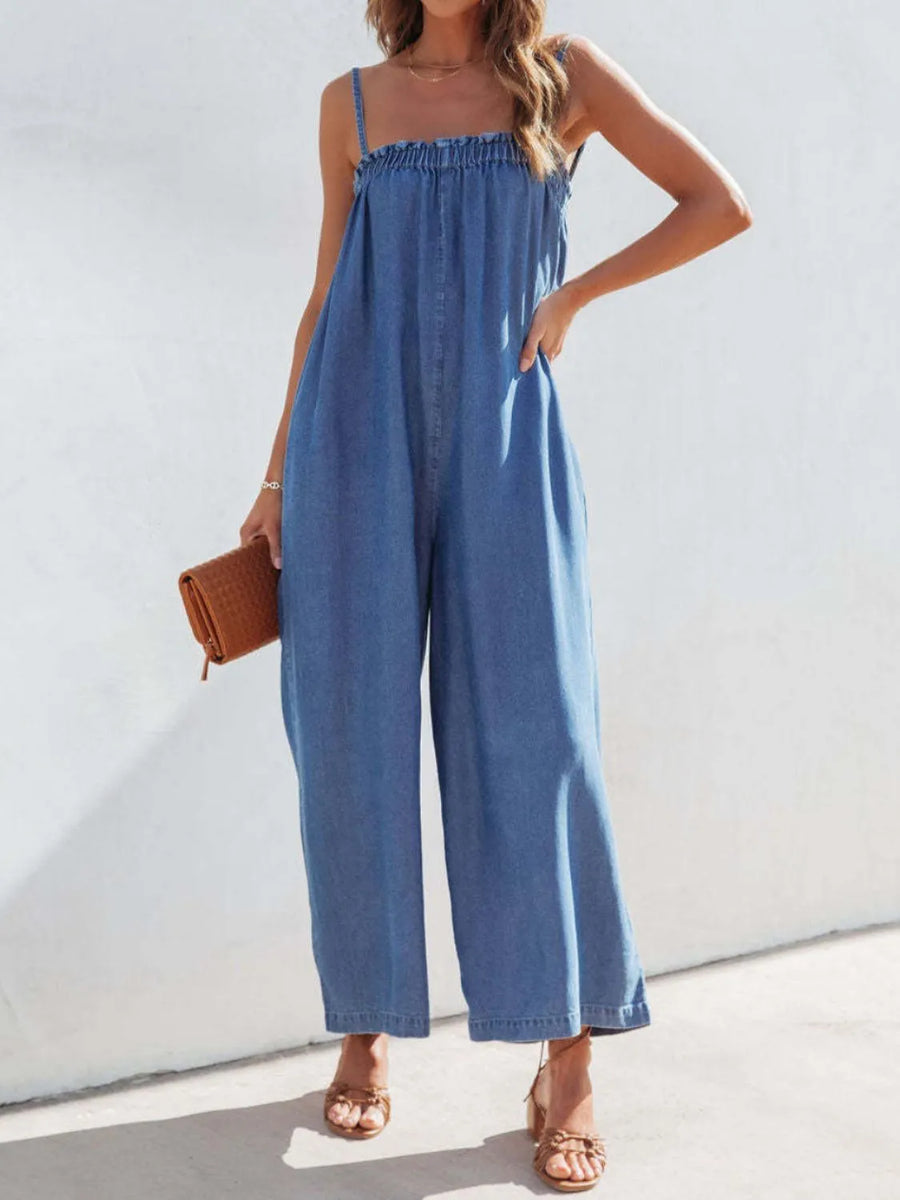 Medium denim jumpsuit with gathered bodice and wide legs.
