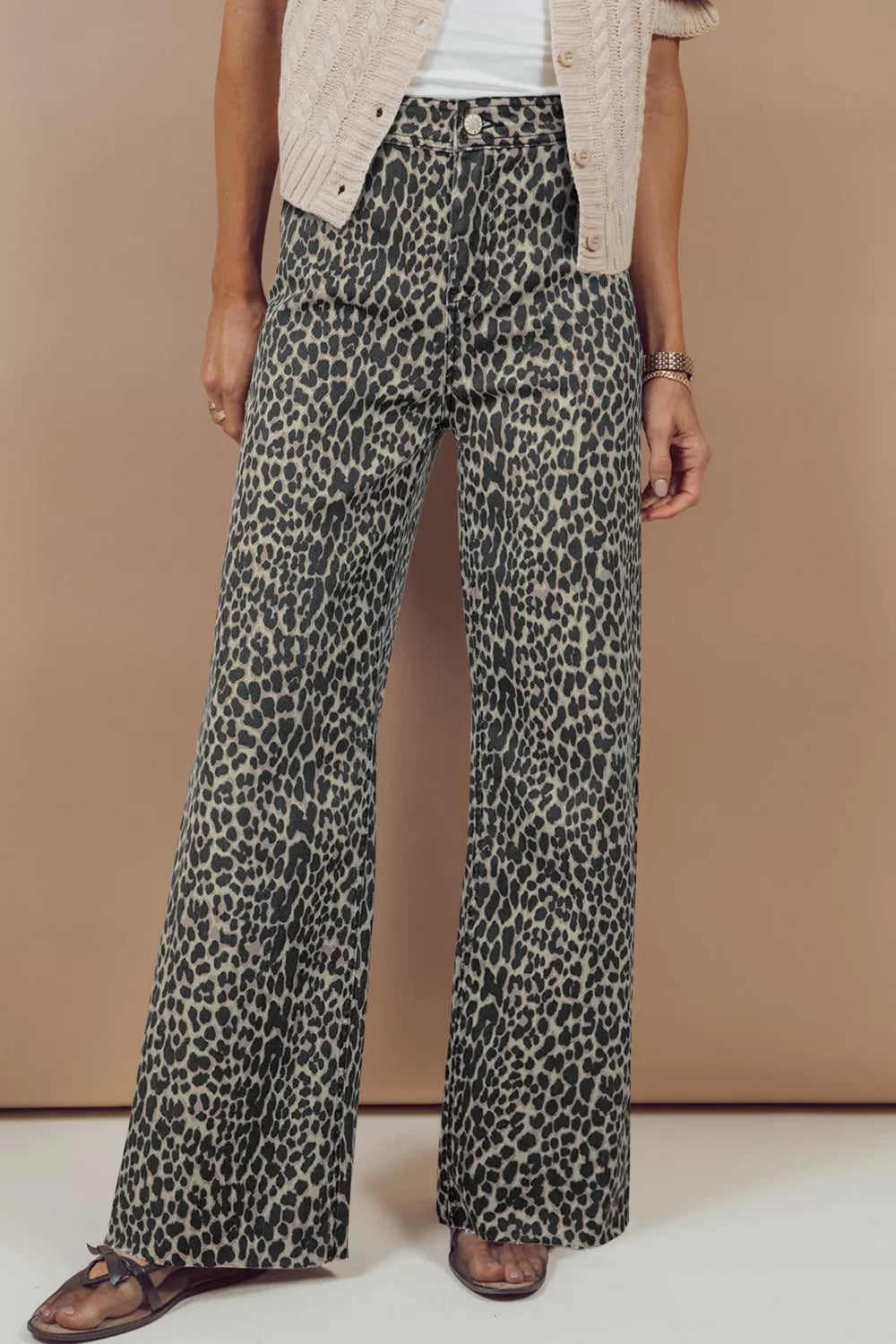 Leopard print high-waist wide-leg jeans with button closure.