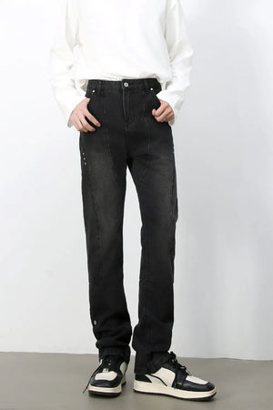 Dark wash denim jeans with asymmetric seams and a straight leg cut.