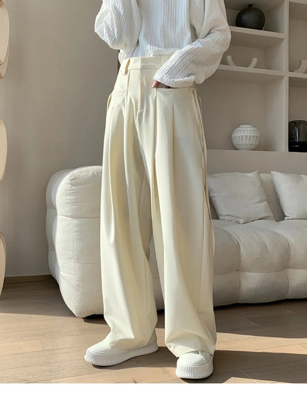 Men's cream wide-leg casual trousers with pleats and a relaxed fit.