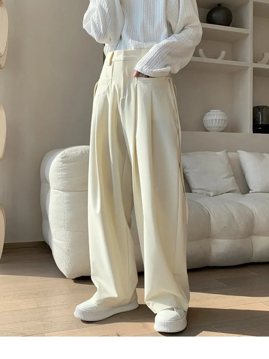 Men's cream wide-leg casual trousers with pleats and a relaxed fit.