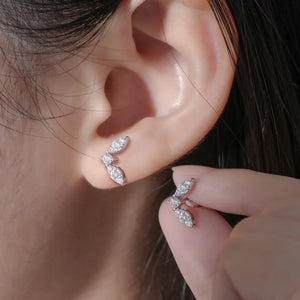 Silver moissanite leaf cluster stud earrings with sparkling stones.