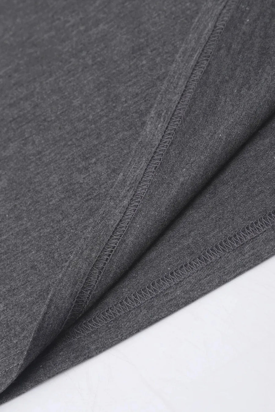 Dark gray t-shirt with visible stitching detail on hem and side seam
