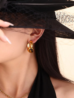 Gold hoop earrings with tiger's eye stone detail, part of a sculptural duo set.