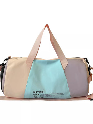 Vibrant pastel nylon duffle bag with color-blocked panels and text detail.