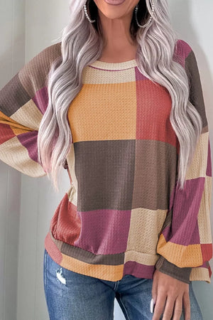 Multicolor patchwork waffle knit top with round neck and long sleeves.