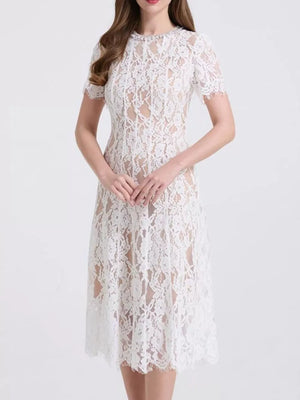 White lace midi dress with short sleeves and pearl embellishments.