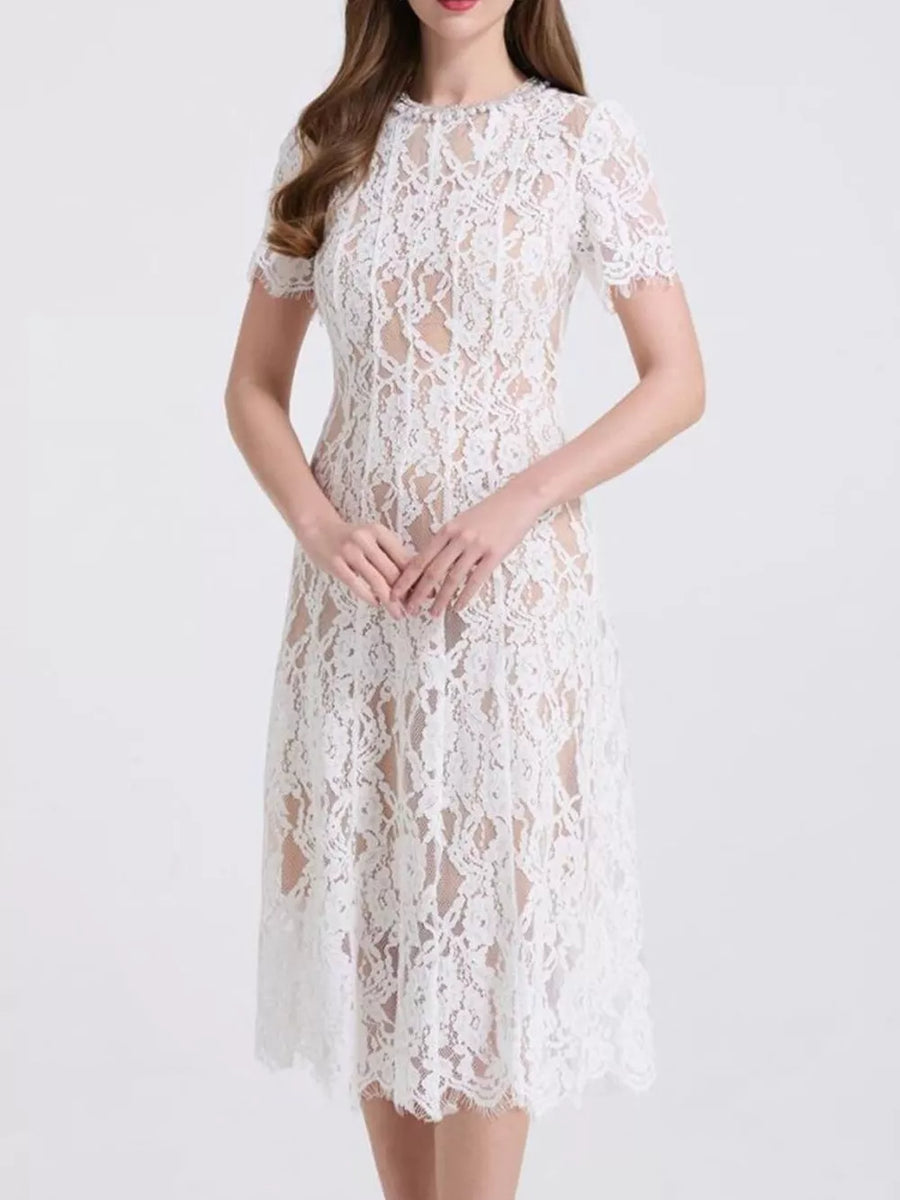 White lace midi dress with short sleeves and pearl embellishments.