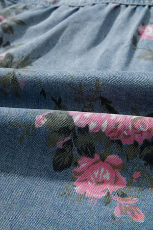 Denim button-up shirt with pink floral print and ruffled detail.