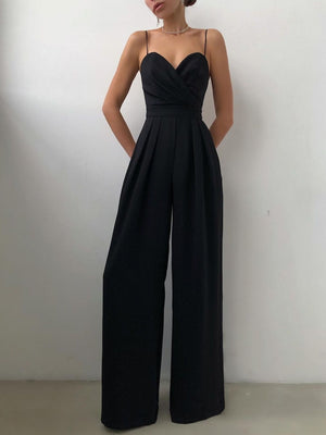 Black ruched spaghetti strap wide-leg jumpsuit with sweetheart neckline and pleated pants.