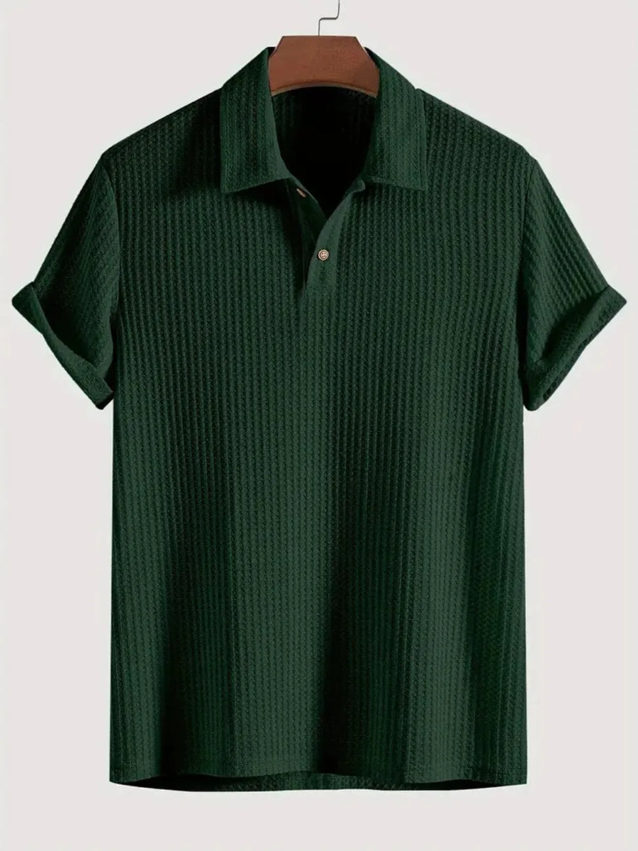 Dark green textured polo shirt with rolled sleeves and a two-button placket.