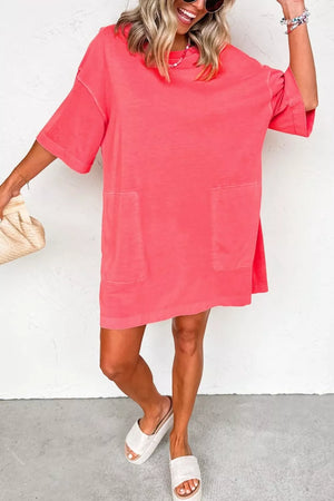 Coral cotton blend t-shirt mini dress with crew neck, drop shoulders, short sleeves, and two front pockets.