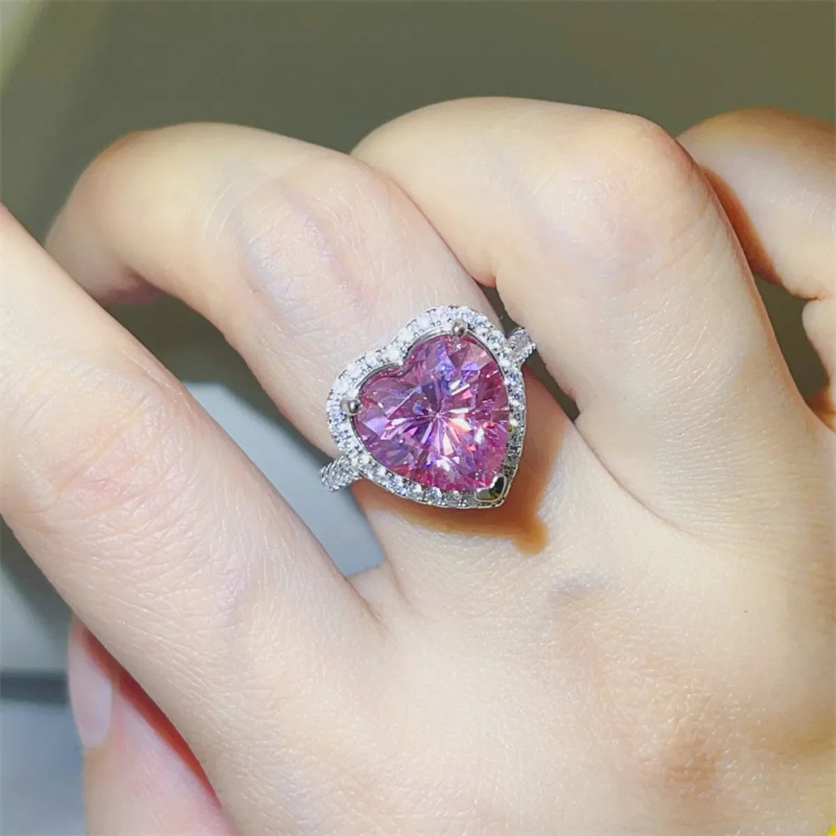 Radiant Heart Moissanite Halo Ring in Fuchsia Pink with a diamond halo setting.