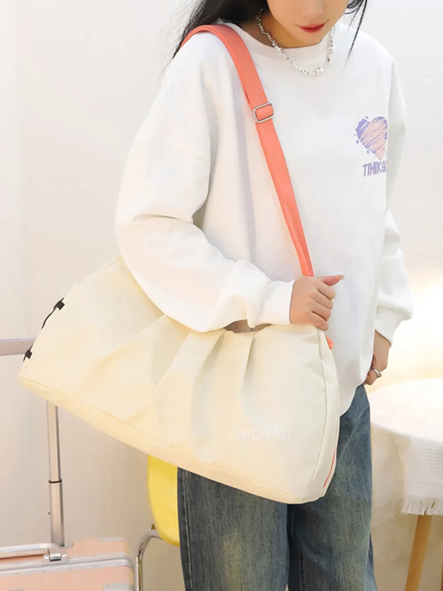 Gathered pleat crossbody bag in beige with adjustable coral strap.