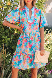 Tropical floral v-neck tiered dress with scalloped trim and puff sleeves.