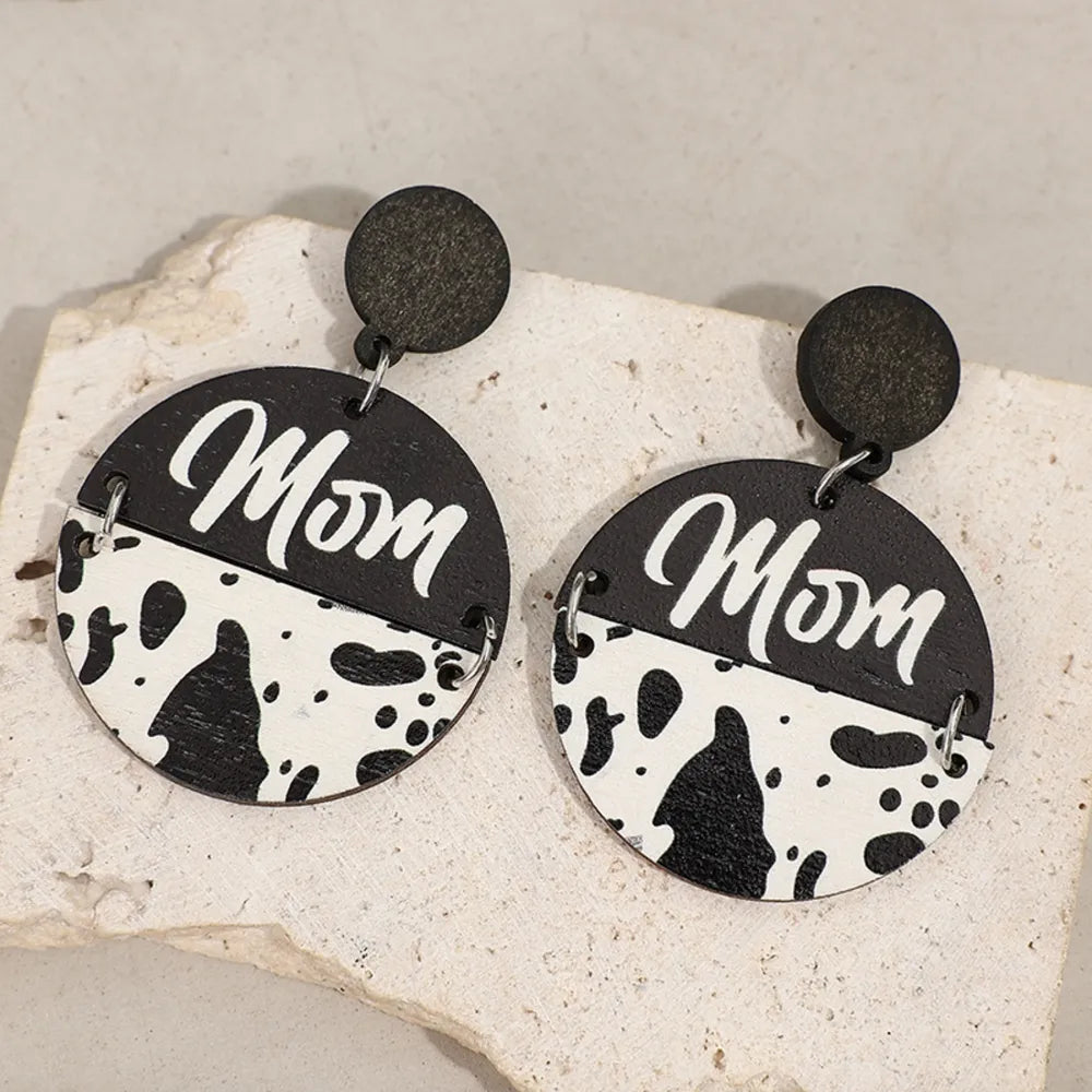Textured wood drop earrings with "Mom" text and cow print detail