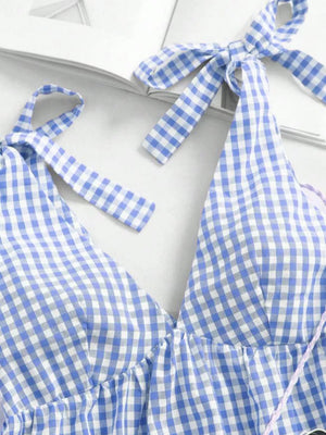 Blue gingham maternity mini dress with tie shoulders and ruffle hem